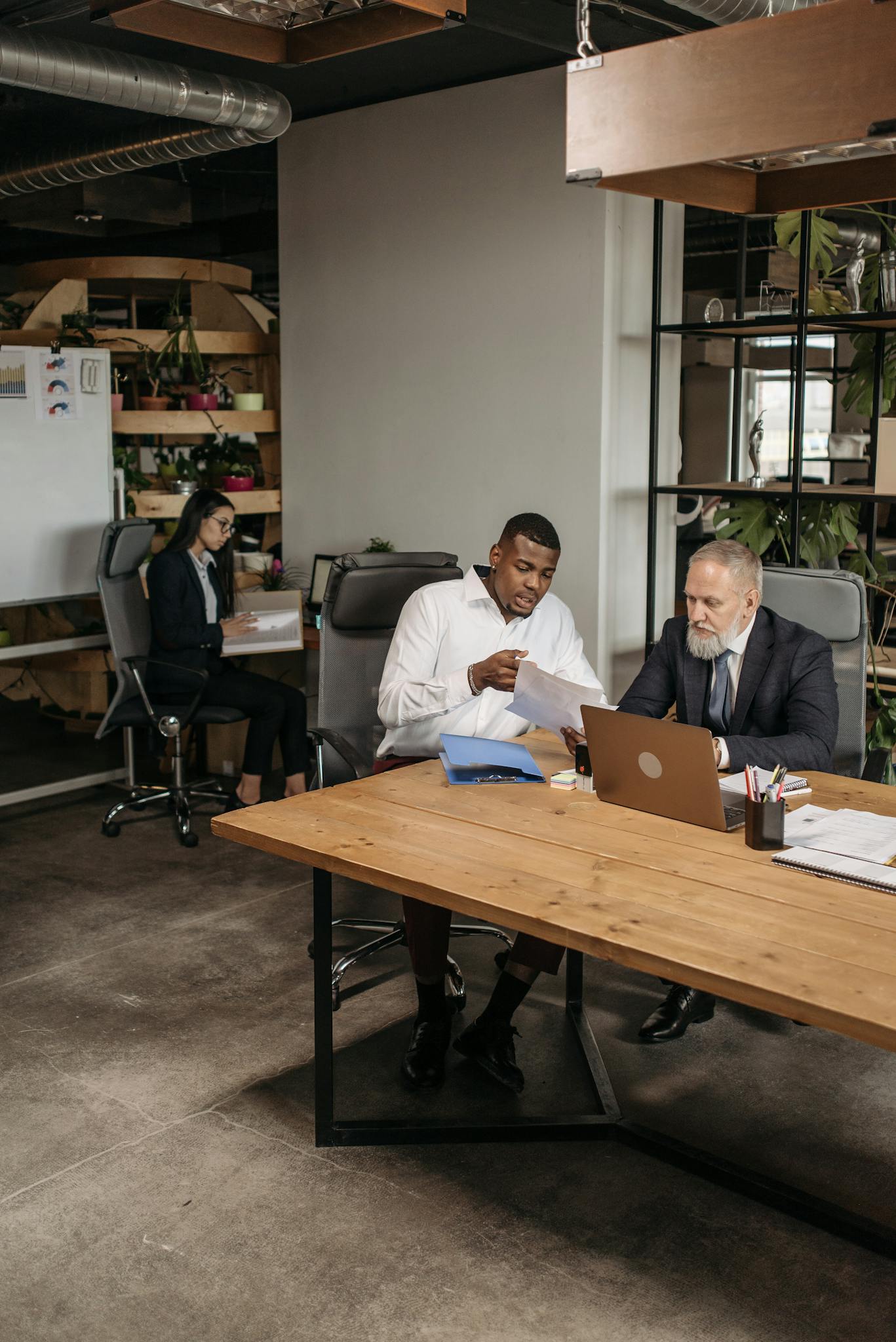 Business professionals working together on a project in a stylish office setting.